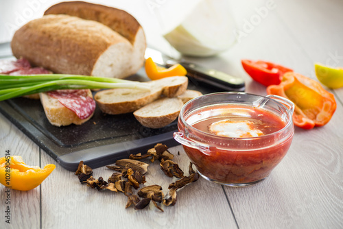 Lenten borscht with dried mushrooms and vegetables, on a light wooden table photo