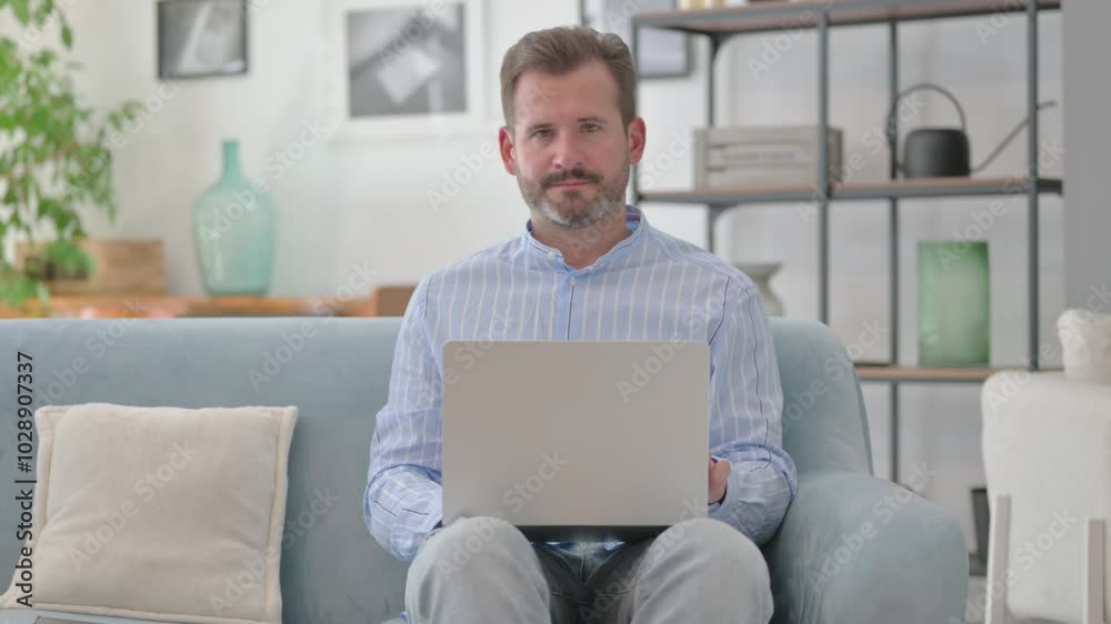 Rejecting Middle Aged Man in Denial with Laptop in Lap Rejecting Middle Aged Man in Denial with Laptop in Lap