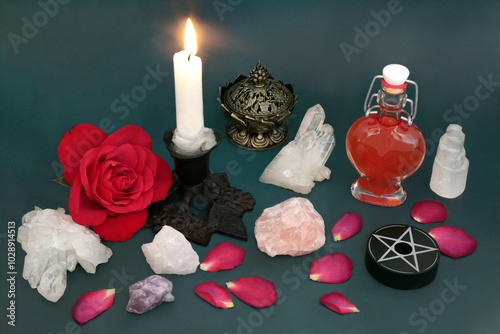 Love potion concept with red rose flower and petals, crystals, heart shape bottle for concoction. Witchcraft occult ancient esoteric theme for Valentines and unrequited love.  photo