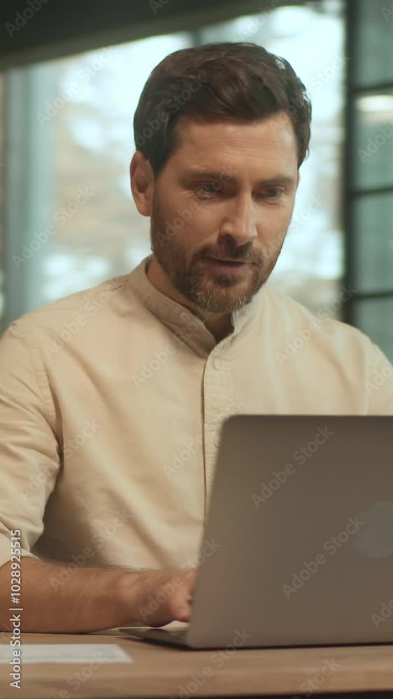 Businessman sitting at desk use laptop hold paper look serious in the office. Work time. Camera moving around. 360 Degree Businessman sitting at desk use laptop hold paper look serious in the office. Work time. Camera moving around. 360 Degree