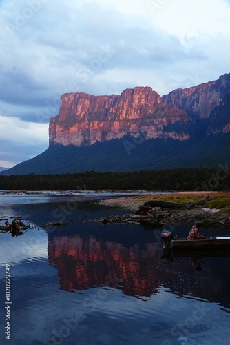 Tepuy en canaima y la gran sabana vista desde isla orquídea mientras el atardecer pinta las montañas. se aprecia el rio carrao  photo