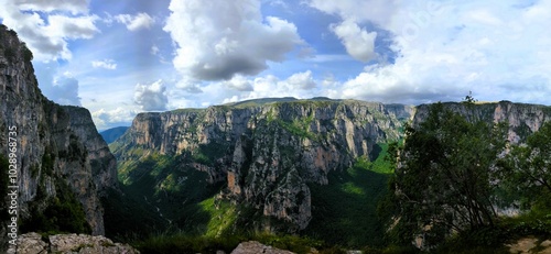 
Panoramic view over the steep and green cliffs of the Vikos Gorge in Epirus, Greece on a summer's day. The gorge in the Pindus Mountains is one of the deepest gorges in the world. Hiking in Greece photo