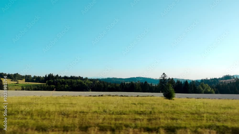 4k Changing scenery outside the cities on a scenic train ride across. Passenger side window view from a moving car in a rural countryside. Car window view of agriculture landscape meadows and woods. 4k Changing scenery outside the cities on a scenic train ride across. Passenger side window view from a moving car in a rural countryside. Car window view of agriculture landscape meadows and woods.
