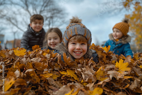 Children playing joyfully in a pile of autumn leaves outdoors