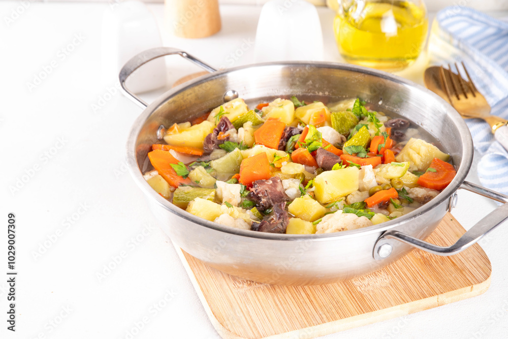 Comfort warm autumn food, balanced lunch, one pot full vegetable stew soup with autumn vegetables cauliflower, zucchini, meat, carrots and potato Comfort warm autumn food, balanced lunch, one pot full vegetable stew soup with autumn vegetables cauliflower, zucchini, meat, carrots and potato