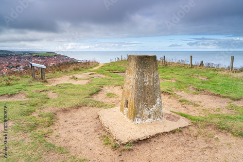 Trig point or Triangulation point at the summit of Beeston Hill in Sheringham, Norfolk, UK in landscape orientation