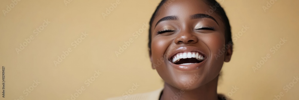 Close-Up Portrait of a Young Black Woman Laughing in Neutral Outfit Close-Up Portrait of a Young Black Woman Laughing in Neutral Outfit
