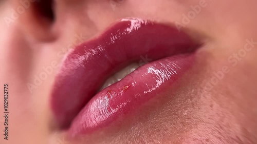 Healed lips with tattooing in a close-up shot, showing mild herpes outbreaks. The makeup procedure is complete, but slight inflammations are still noticeable.