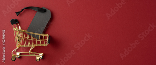 A golden shopping cart with a sale tag on a red background conveying the concept of discounts and sales