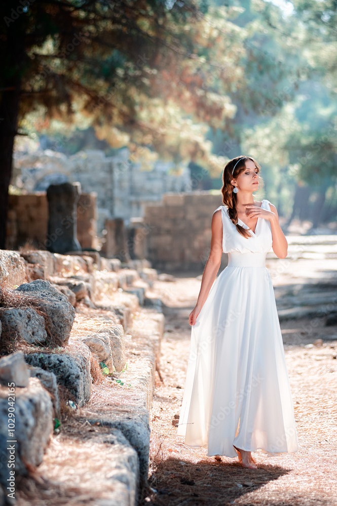 Young beautiful woman wering white dress at antique ruin Young beautiful woman wering white dress at antique ruin