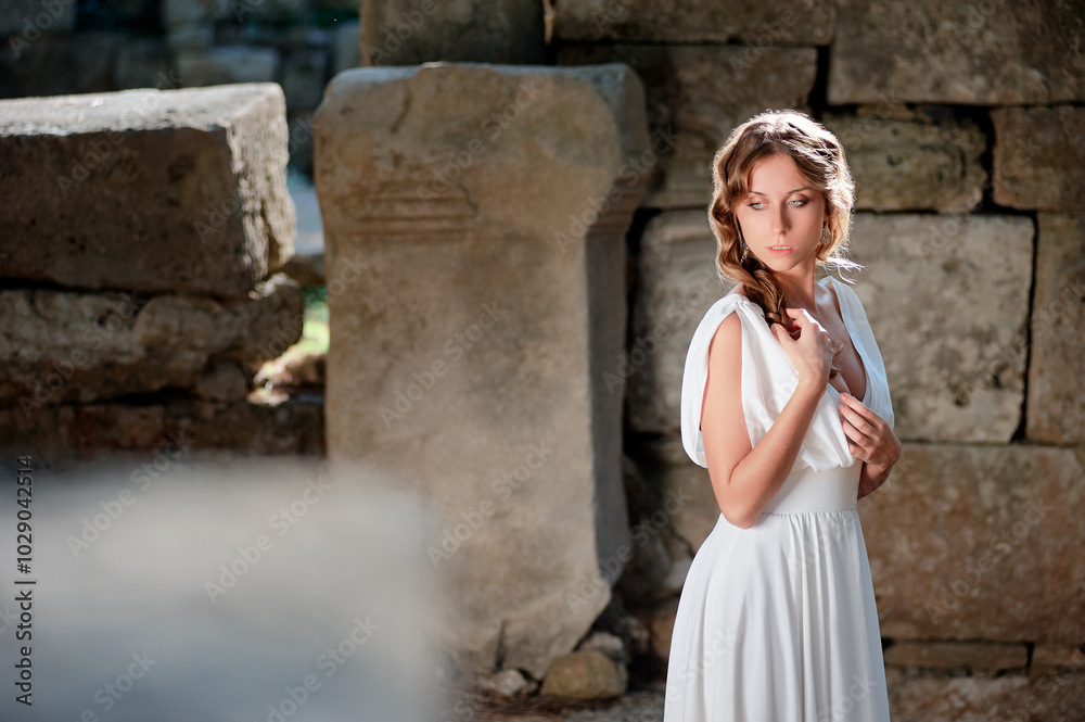 Young beautiful woman wering white dress at antique ruin Young beautiful woman wering white dress at antique ruin