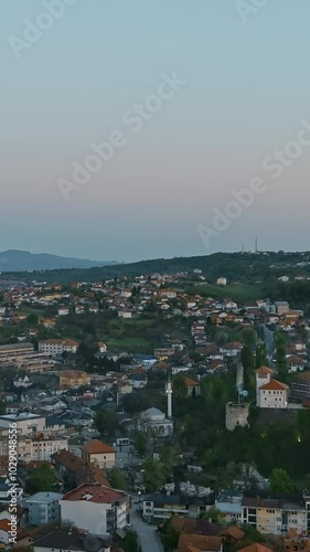 Vertical Screen: Aerial view of Gradacac in Bosnia at sunset during Ramadan, with fireworks and cannon firing to signal the end of fasting. Concept of tradition, religious celebration photo