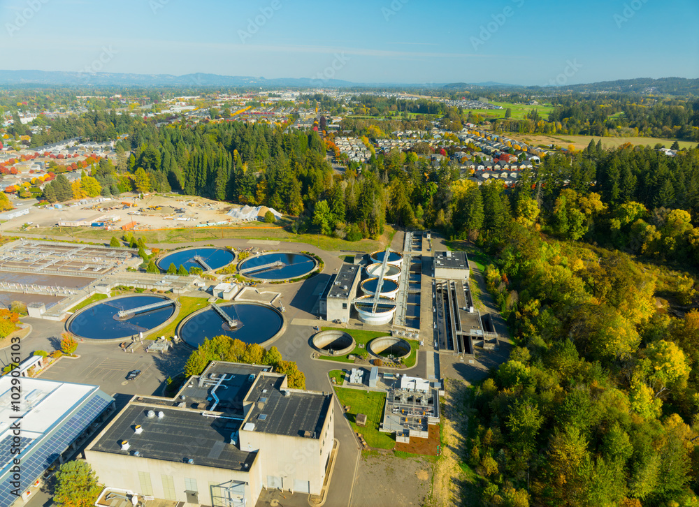 A view of a city with a large water treatment plant in the middle