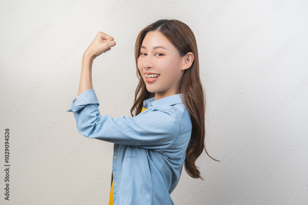 Portrait cheerful beautiful, happy asian young woman, girl gesture confident, proud showing strong powerful body muscle, healthy strength arms and fists, expressing success, isolated on background. Portrait cheerful beautiful, happy asian young woman, girl gesture confident, proud showing strong powerful body muscle, healthy strength arms and fists, expressing success, isolated on background.