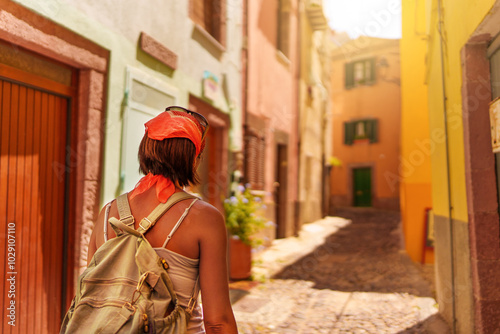 Female traveler walking through the streets of Bosa photo