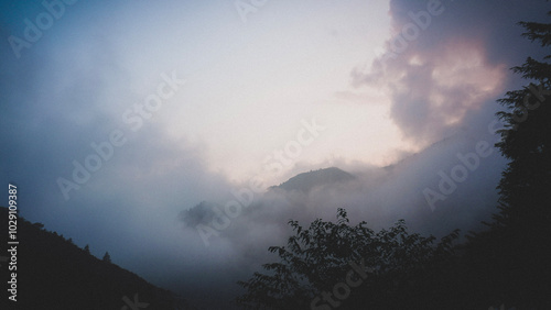 time lapse of clouds over the mountains photo