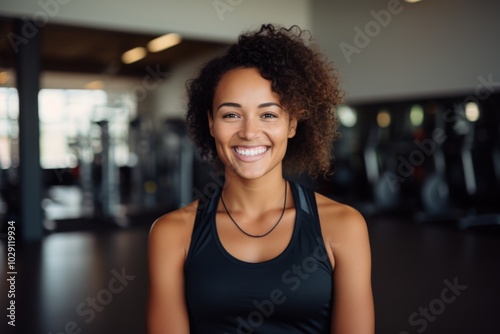 Portrait of a young African American female fitness trainer in gym