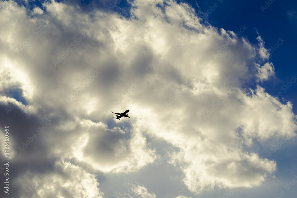The stunning silhouette of an airplane stands out against dramatic and beautiful clouds