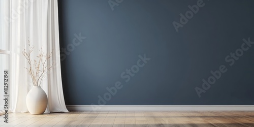 A minimalist room with a navy wall, wooden floor, and a white vase with branches by a curtain.