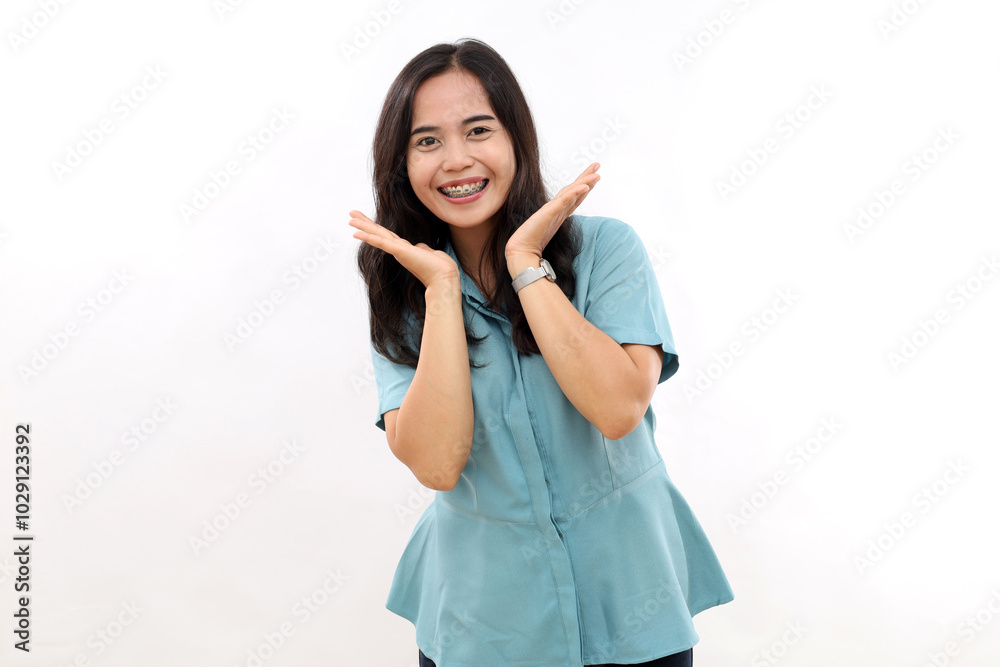 Pleasant looking Asian female smiles, spreads palms near face, expresses positive emotions, healthy skin. Isolated on white Pleasant looking Asian female smiles, spreads palms near face, expresses positive emotions, healthy skin. Isolated on white