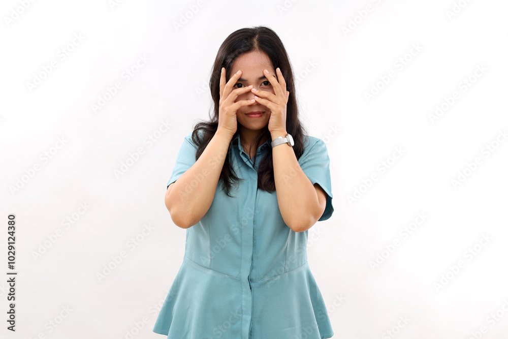 Photo of serious carefree relaxed young Asian woman with natural dark hair keeps hand in face looks determined directly at camera wears shirt isolated white background going to have walk.