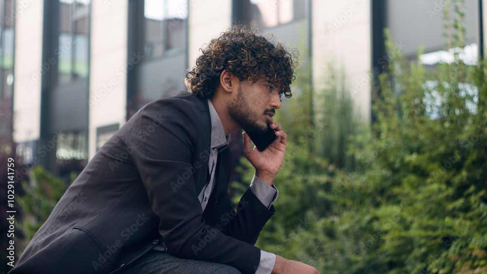 Anxious worried Indian businessman Arabian business man leader employer entrepreneur manager talking mobile phone listening bad news failure problem corporate smartphone conversation in city trouble