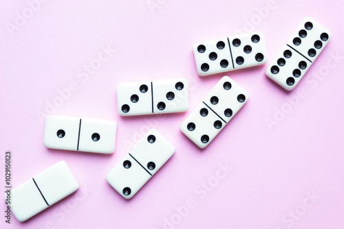 Domino tiles on pink background and space for text.