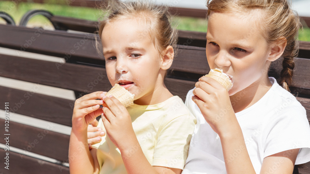 little girl eating ice cream in the summer in the park. cheerful girl with ice cream. little girl eating ice cream in the summer in the park. cheerful girl with ice cream.