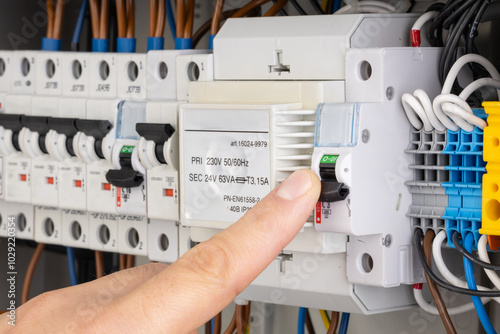 Finger Switching Off Circuit Breaker in Electrical Panel