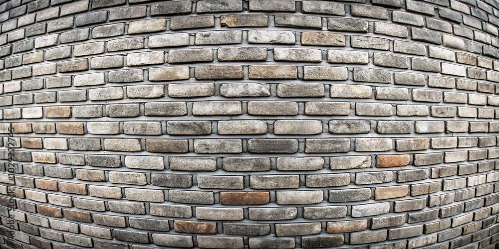 Naklejka premium Fisheye grey brick staggered rustic retro texture wall background