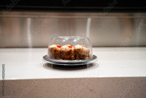 various types of sushi on conveyor belt in a Japanese restaurant. Shushi Go Round is a famous form of fast food in Asia, also known as sushi train. photo