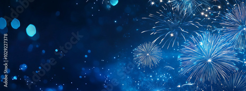 Blue fireworks against a dark blue sky background with copy space, a banner design. New year celebration concept. photo