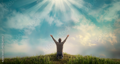 Praising the lord. A man with his arms raised to the sky in thankfulness and prayer. Themes such as Courage, Strength, Humble, Righteous, Sacrifice, Dedication, Exalt, Spirit photo