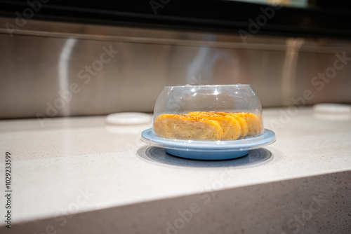 various types of sushi on conveyor belt in a Japanese restaurant. Shushi Go Round is a famous form of fast food in Asia, also known as sushi train. photo