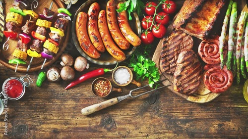 Grilled meats and vegetables on rustic wooden table