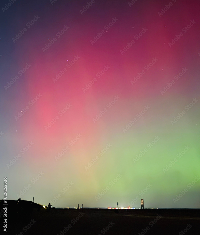 Stunning, dreamy display of vivid colors seen from aurora borealis, northern lights over Long Island, NY, 2024. The G4 geomagnetic storm dazzled over the beach for spectators in awe. Rare surreal Stunning, dreamy display of vivid colors seen from aurora borealis, northern lights over Long Island, NY, 2024. The G4 geomagnetic storm dazzled over the beach for spectators in awe. Rare surreal