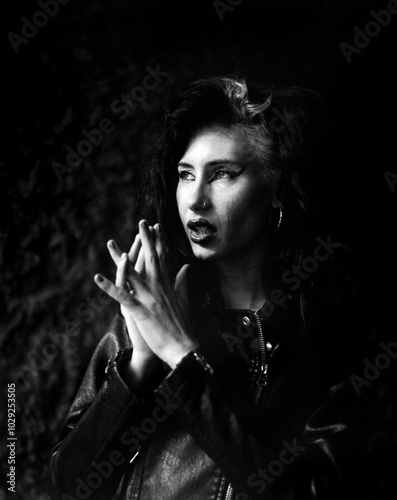 Charismatic portrait of young rocker woman outside.