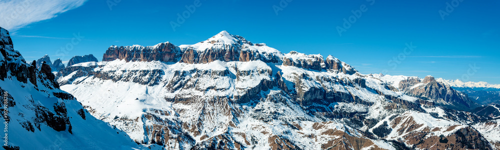Dolomites in Italy. Sella group mountain massif in winter. Panoramic view from Porta Vescovo in Arabba ski resort. Famous ski and snowboard region with famous Sella Ronda ski trail carousel around it