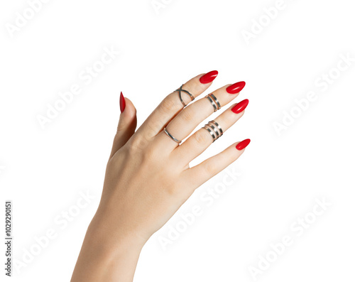 Female hands relaxed, long nails with red gel polish on an emerald white isolated background. A woman with a classic stylish manicure and silver ring set