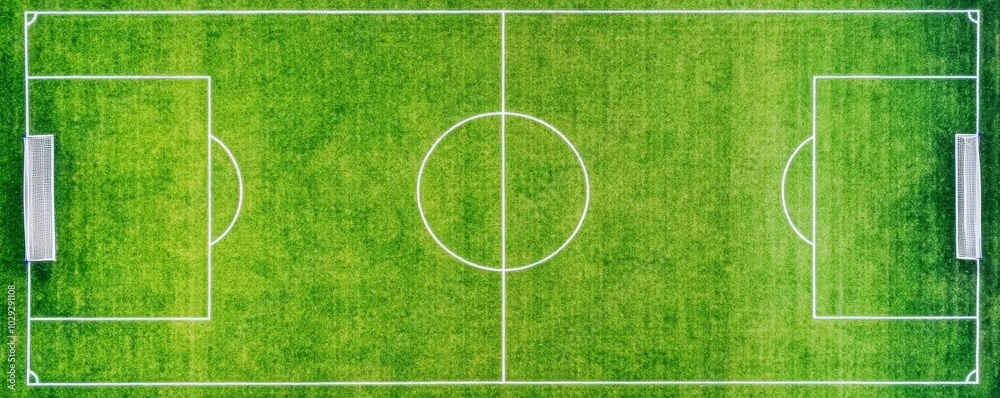 An aerial view of a soccer field with bright green grass and clearly marked lines, showcasing the goals and center circle. An aerial view of a soccer field with bright green grass and clearly marked lines, showcasing the goals and center circle.