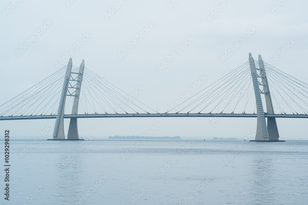 distant bridge over foggy bay on rainy day distant bridge over foggy bay on rainy day