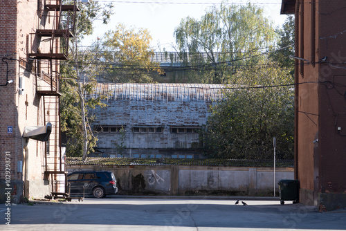 Urban slums. Old buildings, concrete fence, metal hangar. an abandoned place in town. 08.10.2024. Riga. Latvia.