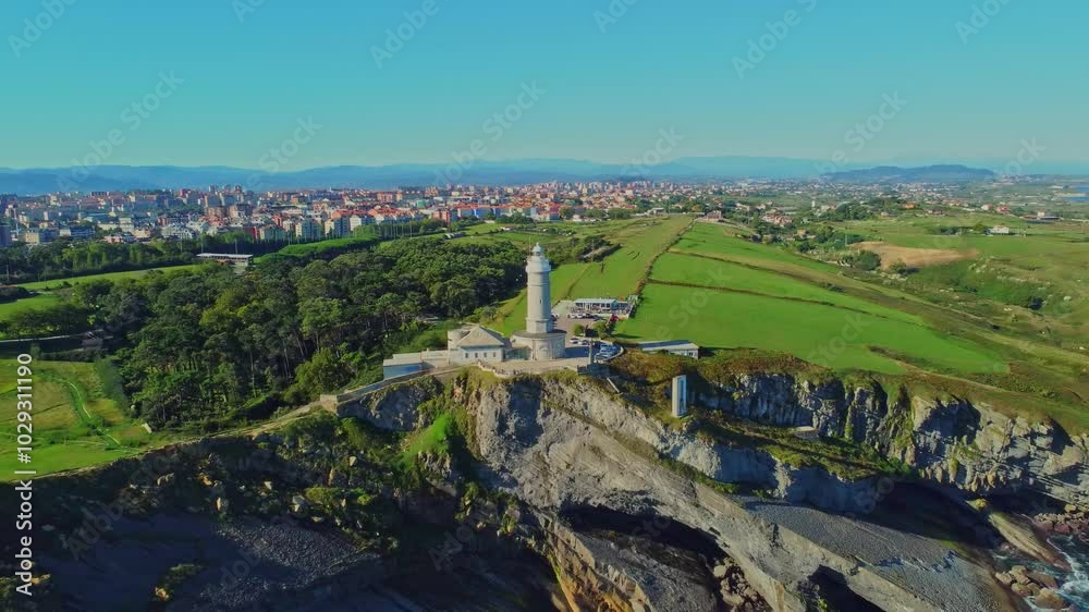 Aerial view of the Cape Mayor lighthouse (Faro de Cabo Mayor) on the rocky coast in Santander, Spain. Aerial view of the Cape Mayor lighthouse (Faro de Cabo Mayor) on the rocky coast in Santander, Spain.