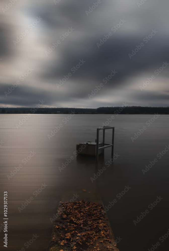Floodgate in pond with autumn leaf. Long exposure, tranquil Czech landscape background Floodgate in pond with autumn leaf. Long exposure, tranquil Czech landscape background