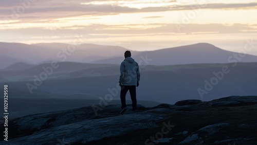 Contemplative Figure Overlooking Dusk Landscap