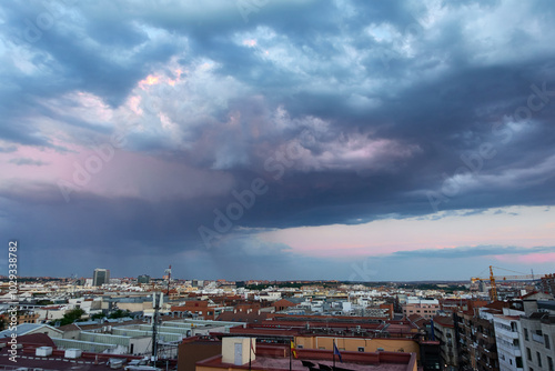 Dusk with colorful clouds and a storm on the horizon, on the outskirts of the city of Madrid, Spain