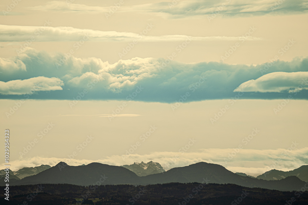 A beautifully cloudy sky with majestic mountains in the background A beautifully cloudy sky with majestic mountains in the background