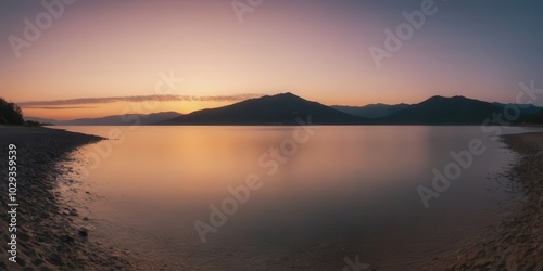 The sun sets over the ocean, its rays reflecting in calm water