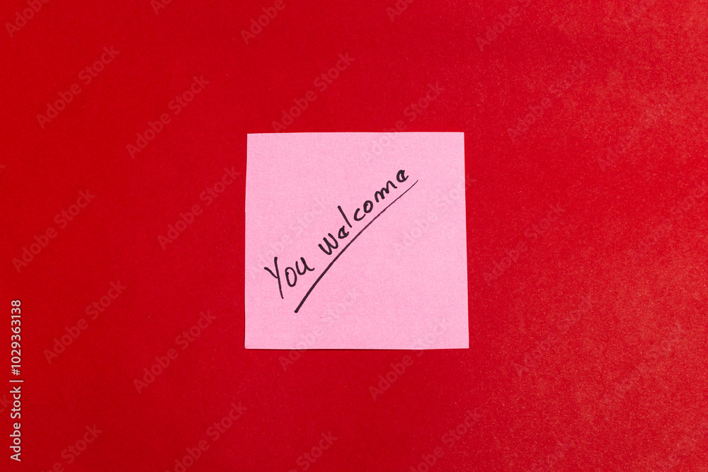 A pink sticky note with the word A pink sticky note with the word