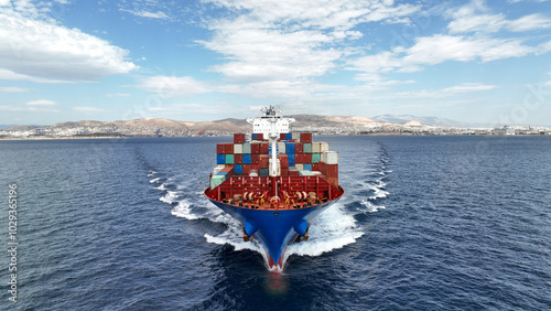 Obraz na płótnie Aerial drone photo of colourful truck size container tanker ship cruising deep blue sea near commercial port of Piraeus, Attica, Greece w salonie